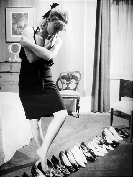 Julie Christie Actress in bedroom trying on shoes in the film Darling Dbase MSI