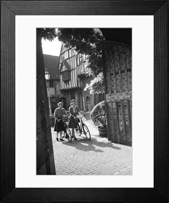 Framed Print : Two women pushing their bicycles through Cheyneys Court in Winchester, Circa 1945 Framed Print : Two women pushing their bicycles through Cheyneys Court in Winchester, Circa 1945
