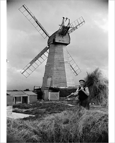 A man working near White Mill in Headcorn, Kent. The mill was Demolished in 1952
