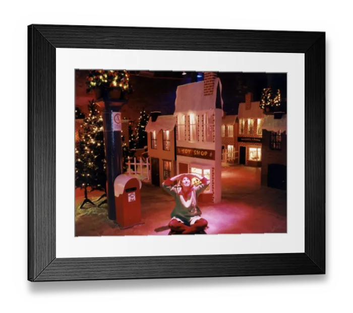 Framed Print : An elf sits in the middle of Santas grotto at the Albert Dock, Liverpool