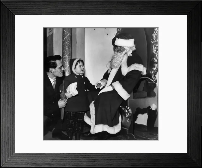 Framed Print : Wonderment in her eyes a young visitor as she gazes up at Santa Claus in Lewis