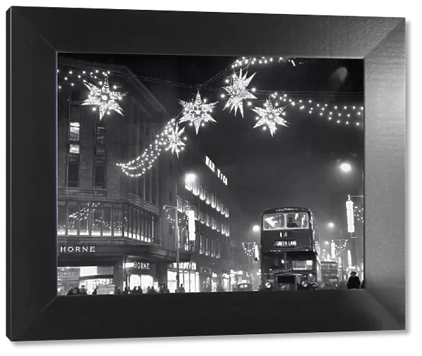 Christmas lights of shimmering stars hang over Lord Street near the corner of Whitechapel