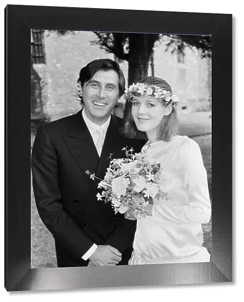 Pop star Bryan Ferry poses with his bride Lucy Helmore after thier wedding ceremony at St