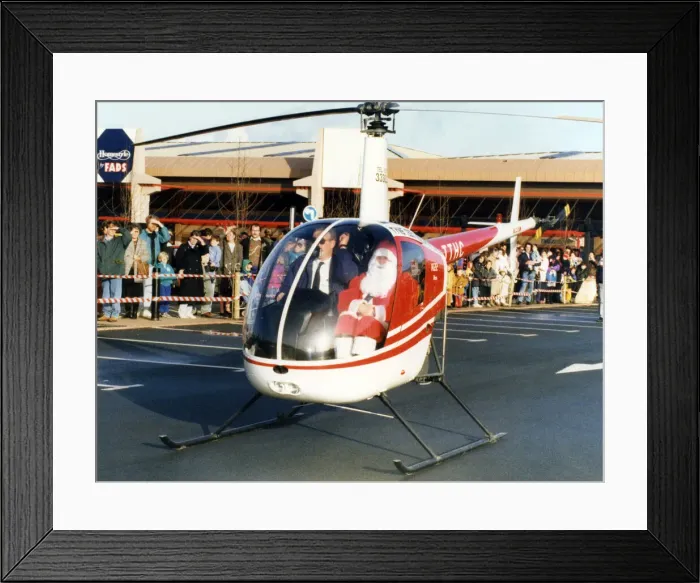 Framed Print : Father Christmas arriving in style, in a helicopter at the car park of Homestyle by FADS Framed Print : Father Christmas arriving in style, in a helicopter at the car park of Homestyle by FADS