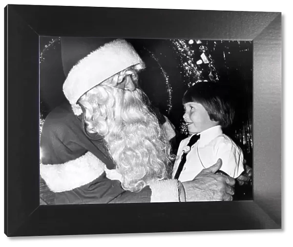 A young girl meeting Father Christmas in the grotto at Debenham s, Teesside