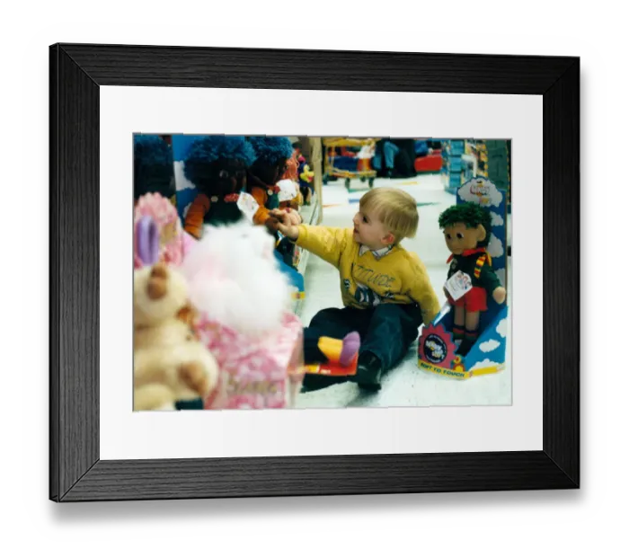 Framed Print : Child, Lewis Cromby aged 3, explores Bendy Soft toy during pre christmas shopping trip Framed Print : Child, Lewis Cromby aged 3, explores Bendy Soft toy during pre christmas shopping trip