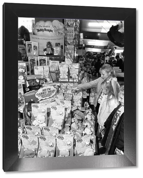 Christmas Shopping Trip, 25th November 1986. Young girls examine Gabby Bear Dolls