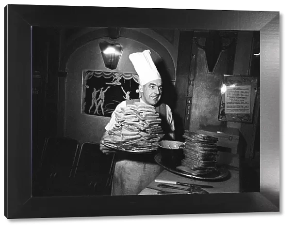 A chef with two huge piles of toast. April 1947