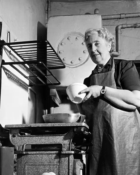 British author Agatha Christie pictured cooking in the kitchen at her home at Winterbrook