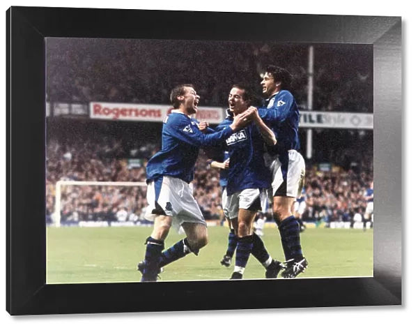 Michael Branch of Everton celebrates a goal against Leicester congratulated by teammates
