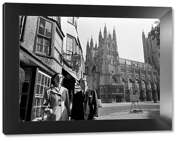 A couple in Canterbury during Canterbury Week, Kent. Canterbury Cathedral in