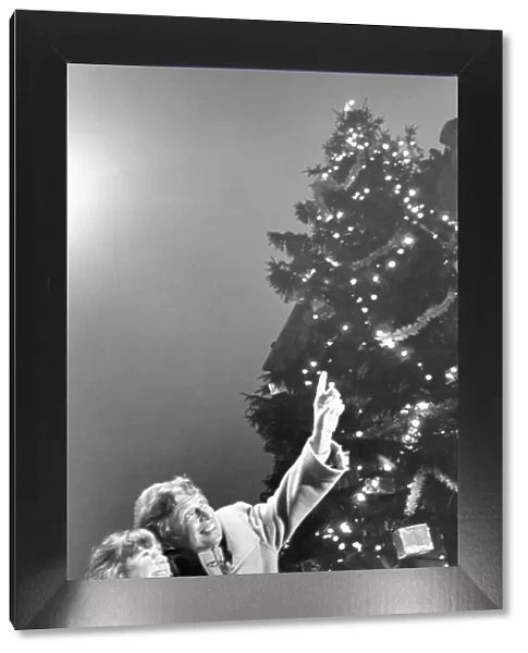Tommy Steele shares the joy of Christmas with Claire Ryan aged 8 of Speke
