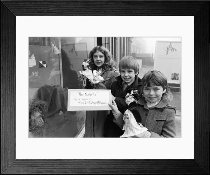 Framed Print : Helme Junior School pupils arranging their Nativity scene in the window of a Meltham Framed Print : Helme Junior School pupils arranging their Nativity scene in the window of a Meltham