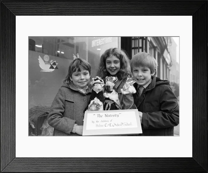 Framed Print : Helme Junior School pupils arranging their Nativity scene in the window of a Meltham Framed Print : Helme Junior School pupils arranging their Nativity scene in the window of a Meltham