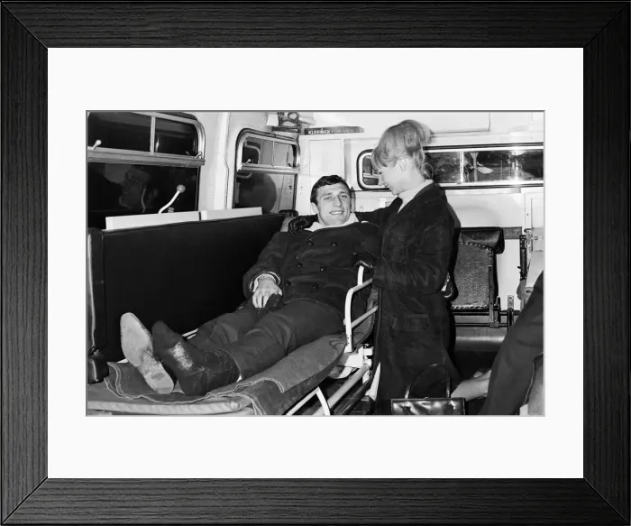 Framed Print : Charlton Athletic footballer Mike Bailey returns to London with his wife after breaking Framed Print : Charlton Athletic footballer Mike Bailey returns to London with his wife after breaking