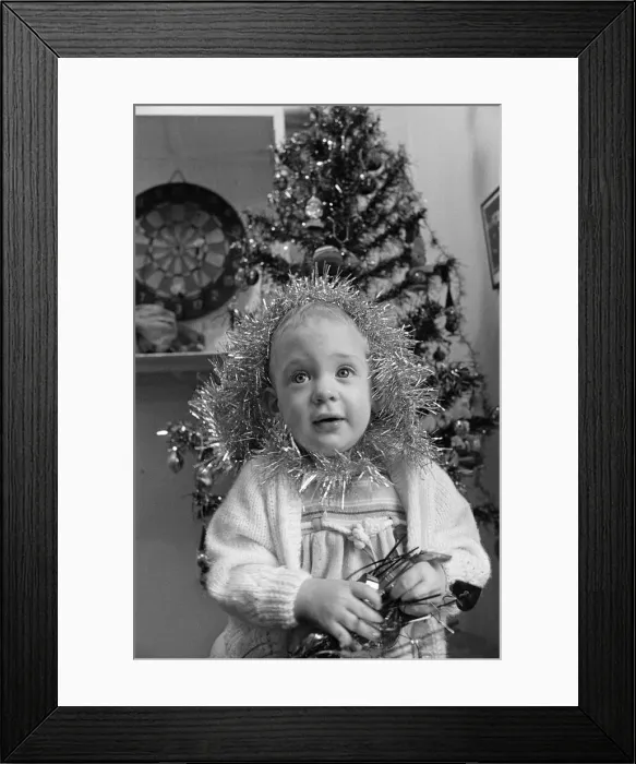 Framed Print : Meltham Fire Station Christmas party - young girl with tinsel wrapped round her head Framed Print : Meltham Fire Station Christmas party - young girl with tinsel wrapped round her head