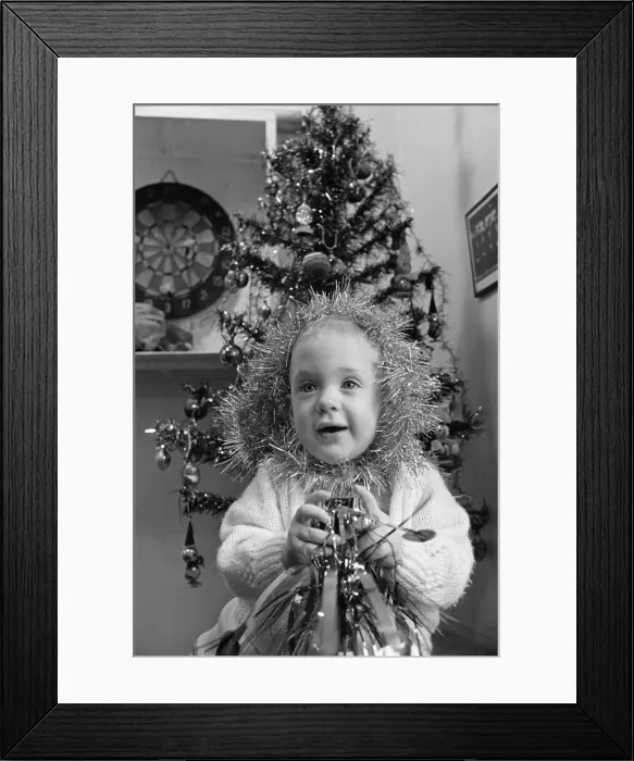 Framed Print : Meltham Fire Station Christmas party - young girl with tinsel wrapped round her head Framed Print : Meltham Fire Station Christmas party - young girl with tinsel wrapped round her head