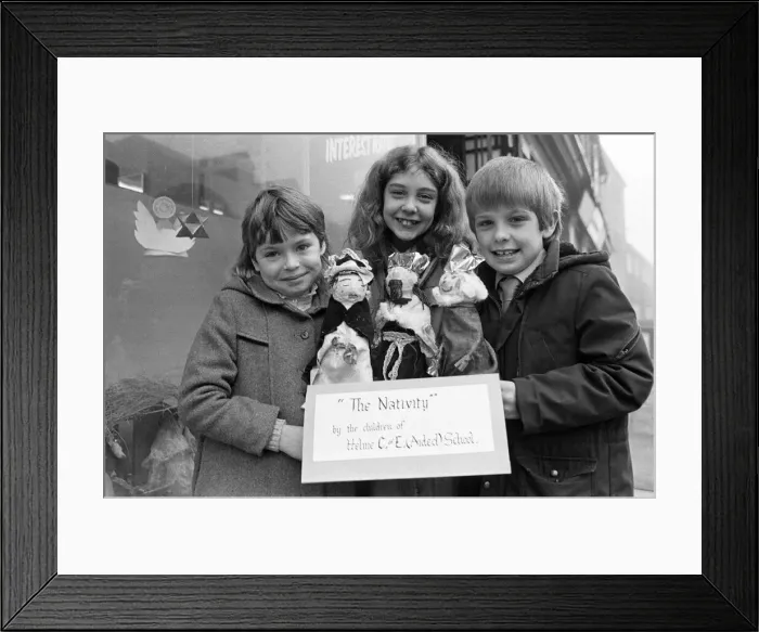 Framed Print : Helme Junior School pupils arranging their Nativity scene in the window of a Meltham Framed Print : Helme Junior School pupils arranging their Nativity scene in the window of a Meltham