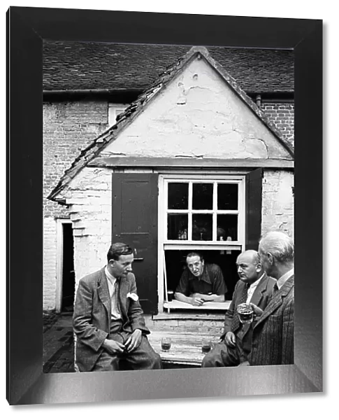 A group of men enjoy a game of Bat and Trap at a pub in Kent