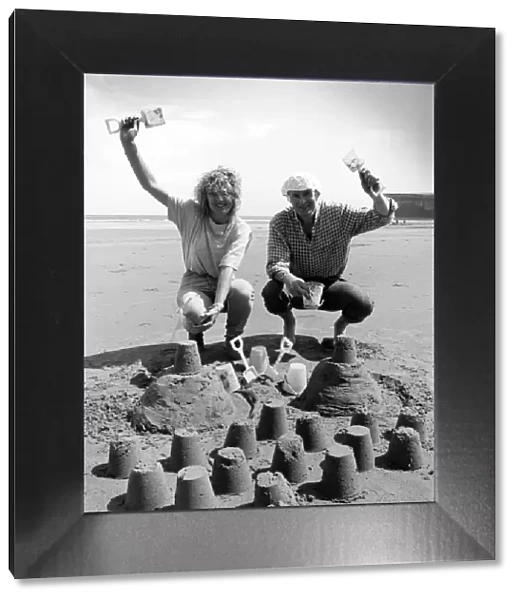 Chris Bird and Carole Smithson get in some practice at the sandpit building for
