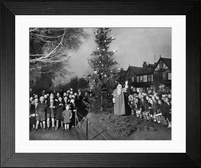Framed Print : Father Christmas leads school children in carol singing around the Council