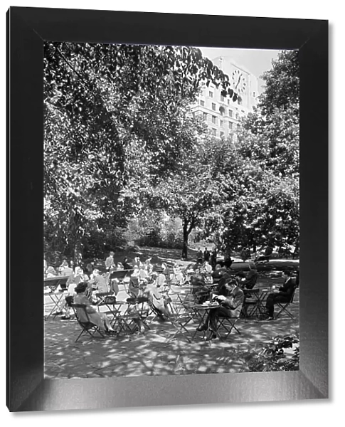 People enjoying afternoon tea in Victoria Gardens on the Embankment, London