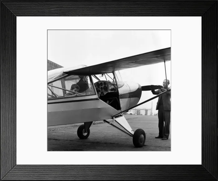 Framed Print : Mrs Diana Freeman from Headcorn, Kent explains the controls of her Auster aircraft wile Framed Print : Mrs Diana Freeman from Headcorn, Kent explains the controls of her Auster aircraft wile