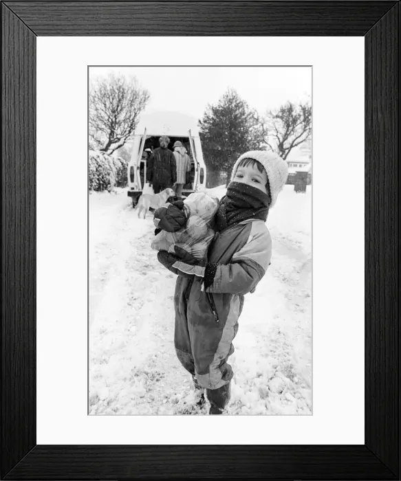 Framed Print : John Martin aged 3, collects supplies from the mobile shop outside his home in Potto