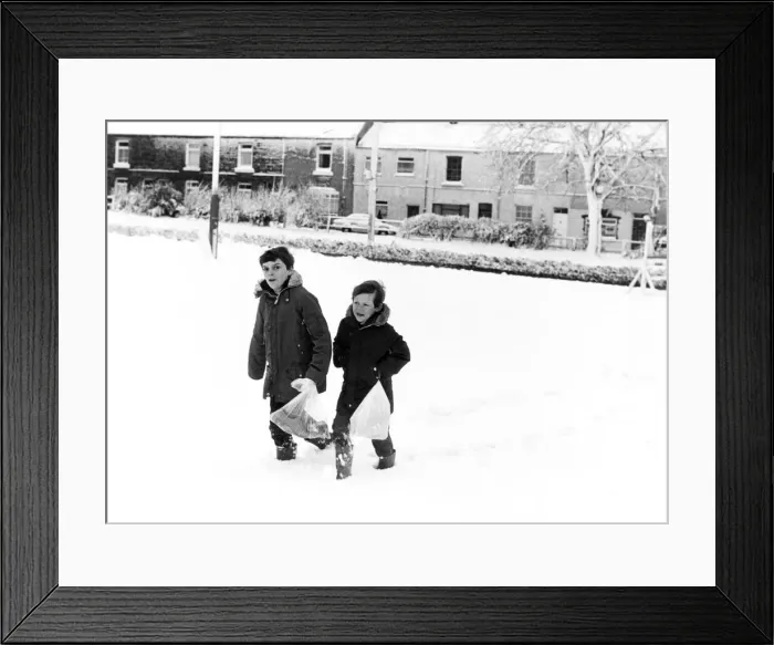 Framed Print : Christian Clapton (left) and Paul Isbel (right) trudge through the thick snow to get to Framed Print : Christian Clapton (left) and Paul Isbel (right) trudge through the thick snow to get to