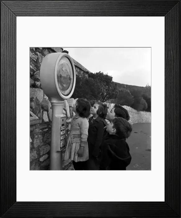 Framed Print : Children play on the weighing machine at Plymouth Promenade, Devon. 18th January 1954 Framed Print : Children play on the weighing machine at Plymouth Promenade, Devon. 18th January 1954