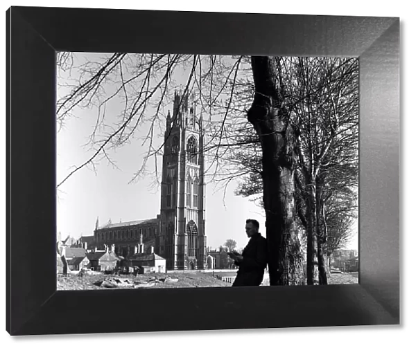 A man reading near St Botolphs Church in Boston, Lincolnshire. 2nd April 1953