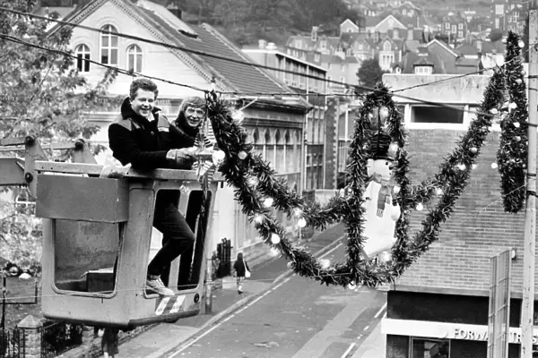 Workmen put the finishing touches to Christmas decorations, Swansea, Wales