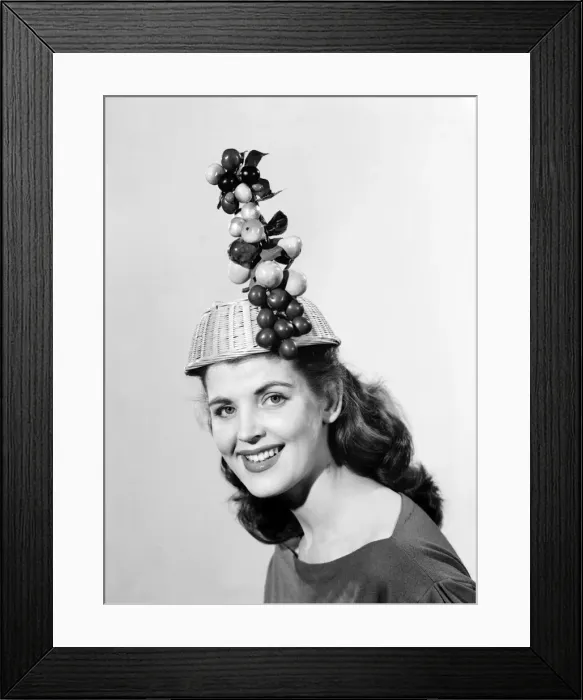 Framed Print : Woman wearing fruit basket hat. 1957 Framed Print : Woman wearing fruit basket hat. 1957