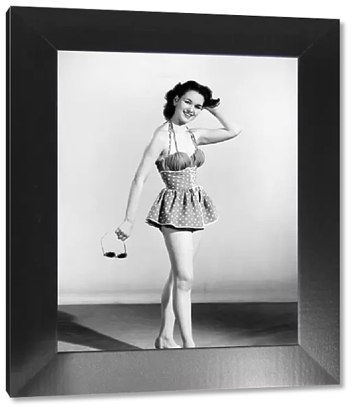 Woman wearing swimming costume. 1955