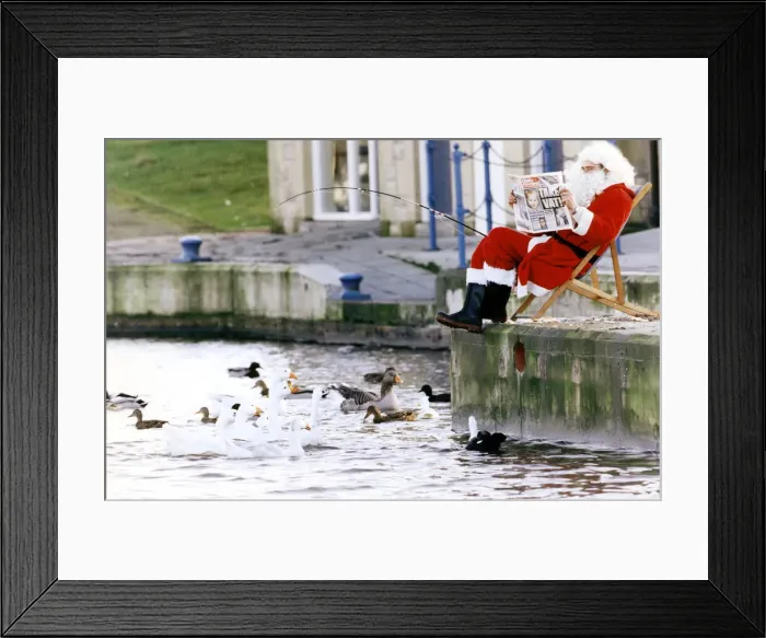 Framed Print : Father Christmas taking a break for the hustle and bustle of Christmas by going fishing