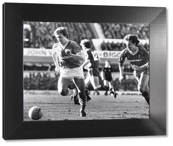 Everton footballer Kevin Sheedy on the ball chased by Mark Lawrenson during the English