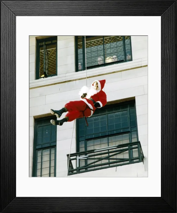 Framed Print : Soldier John Greenfield, dressed as Father Christmas, was abseiling down the side of a Framed Print : Soldier John Greenfield, dressed as Father Christmas, was abseiling down the side of a