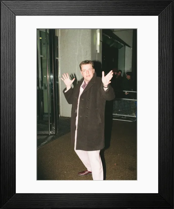 Framed Print : Suggs, lead singer of British ska group Madness, arrives for the British Comedy Awards
