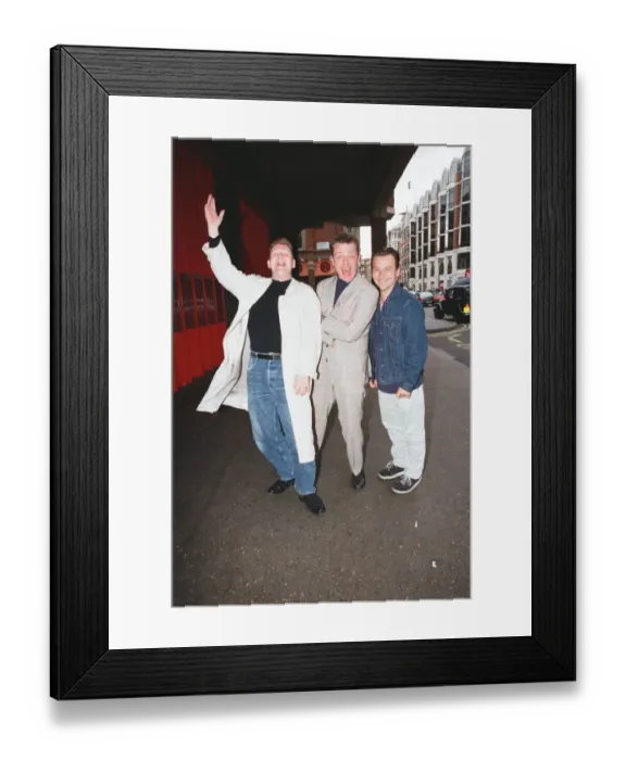 Framed Print : Suggs, lead singer of British ska group Madness, with two members of the group posing for