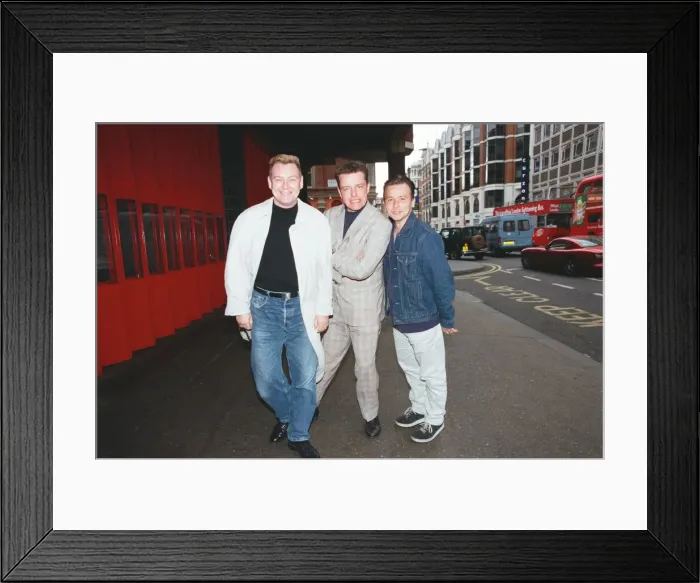 Framed Print : Suggs, lead singer of British ska group Madness, with two members of the group posing for Framed Print : Suggs, lead singer of British ska group Madness, with two members of the group posing for