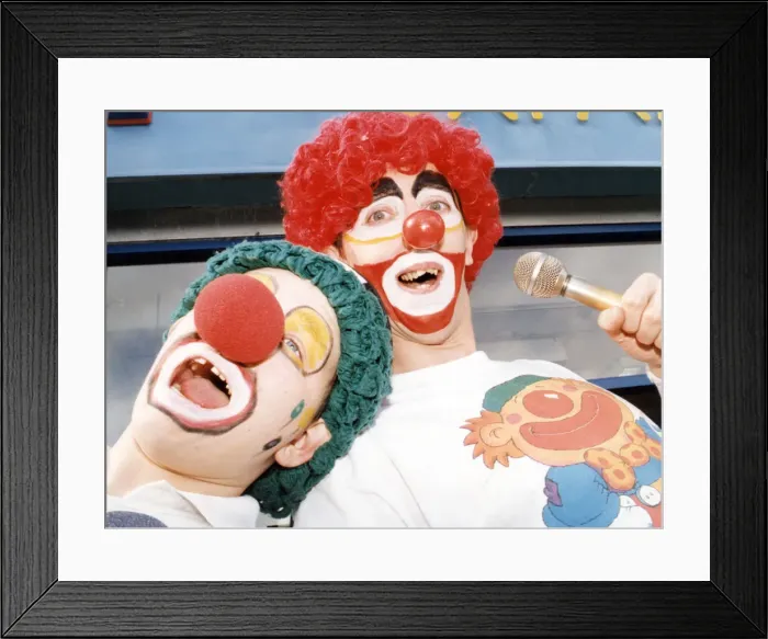 Framed Print : Karaoke clowns Peter Watson (right) and Stephen Brooks entertain shoppers in Stockton
