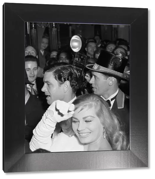 Anita Ekberg and Anthony Steele caught in the surging crowds outside the Empire Theatre
