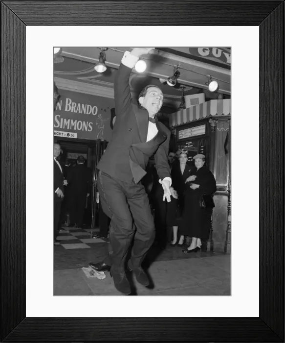 Framed Print : Norman Wisdom seen here waving to the crowds at the premiere of Guys Framed Print : Norman Wisdom seen here waving to the crowds at the premiere of Guys