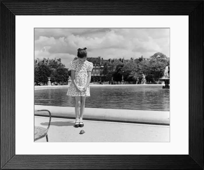 Framed Print : France Paris -A young girl takes her Tortoise for a walk in the park during the state of Framed Print : France Paris -A young girl takes her Tortoise for a walk in the park during the state of