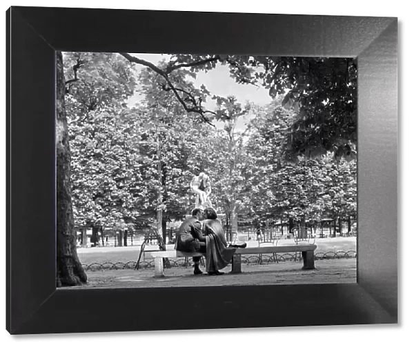 Lovers kiss in a Paris park by a statue during the 1958 state of emegency