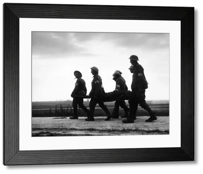 Framed Print : Battle of the Somme: A stretcher case seen in silhouette being brought in from La