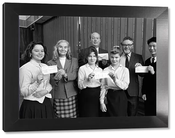 Cheques are presented to charity representatives at All Saints RC High School