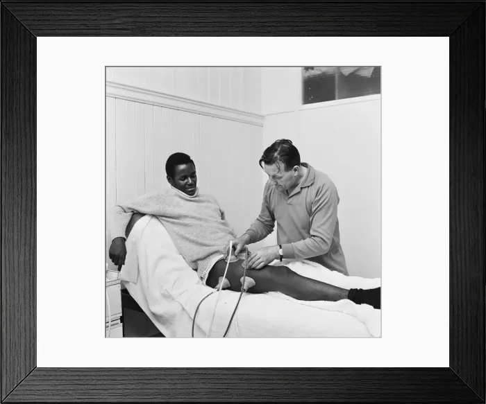 Framed Print : Liverpool team trainer Bob Paisley tends to William Louther Framed Print : Liverpool team trainer Bob Paisley tends to William Louther