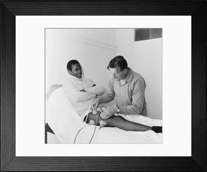 Framed Print : Liverpool team trainer Bob Paisley tends to William Louther Framed Print : Liverpool team trainer Bob Paisley tends to William Louther