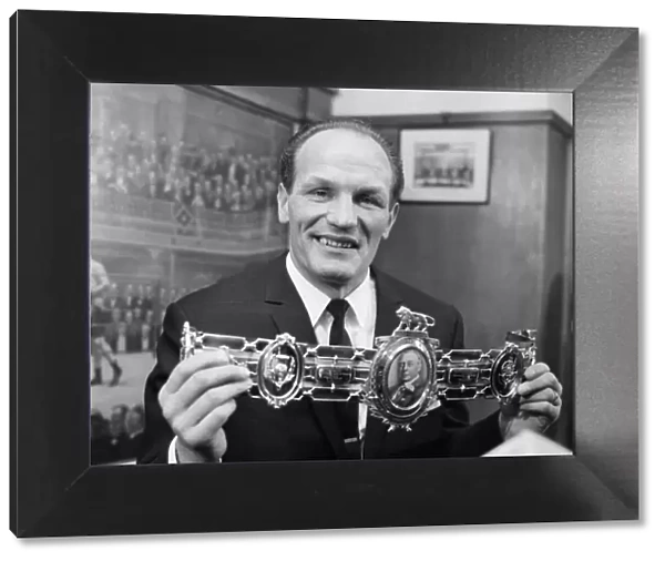 Henry Cooper, proudly shows off his 3rd Lonsdale bet, which was presented to him by Sir